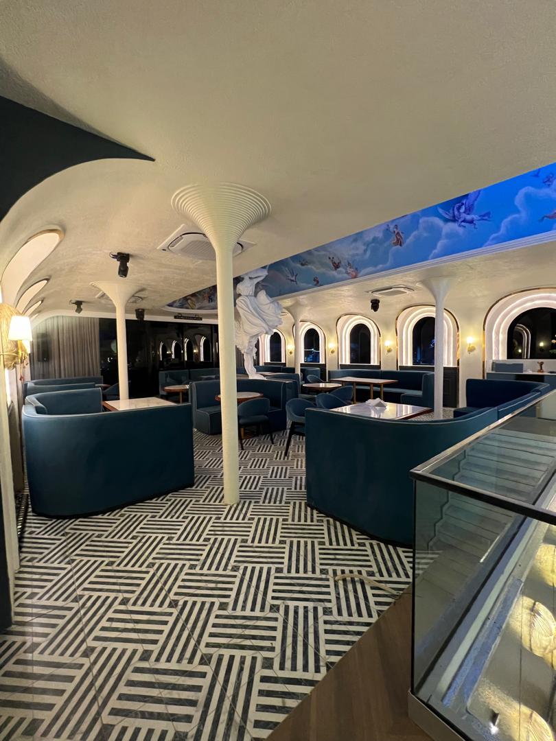 Wood-finished lounge with soft carpet and recessed ceiling lights